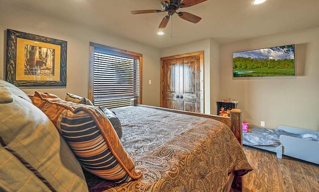 bedroom with hardwood / wood-style flooring, a closet, and ceiling fan