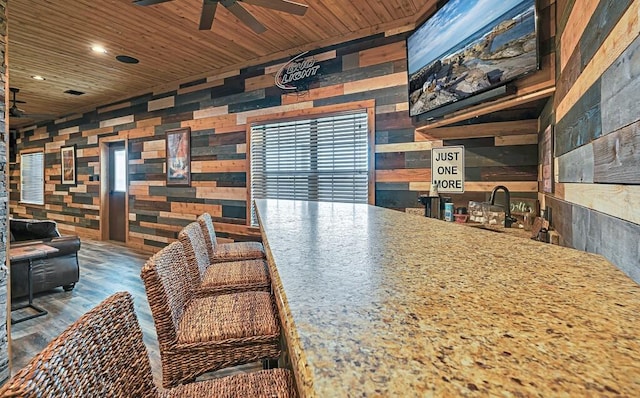 interior space featuring dark hardwood / wood-style flooring, sink, ceiling fan, and wood ceiling