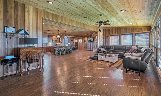 living room featuring wood walls and wooden ceiling