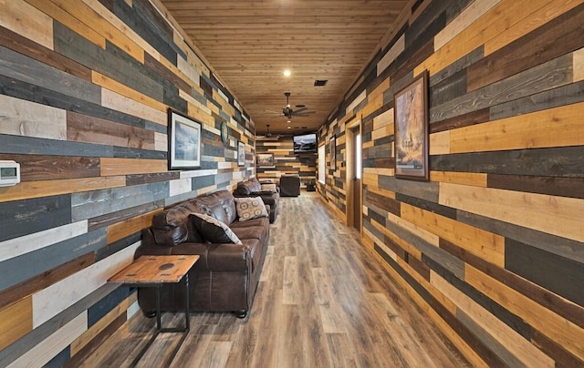 hall featuring dark hardwood / wood-style floors, wooden walls, and wood ceiling