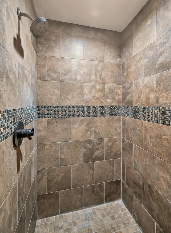 bathroom with tiled shower