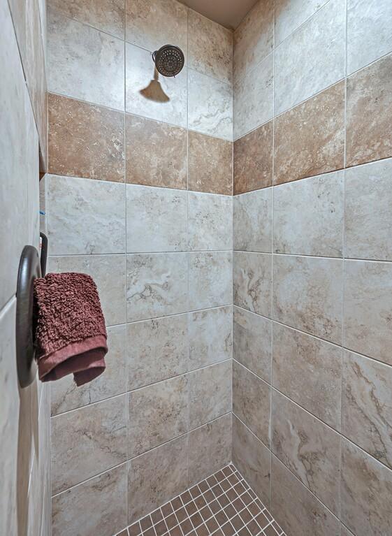 bathroom with tiled shower