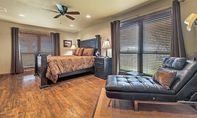 bedroom with dark hardwood / wood-style floors and ceiling fan