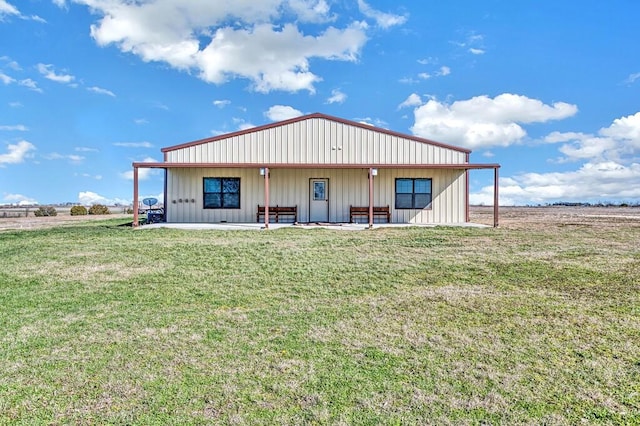 rear view of property with a yard and a patio area