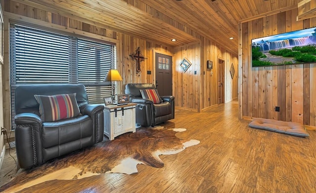 living room featuring hardwood / wood-style flooring, wooden walls, and wooden ceiling