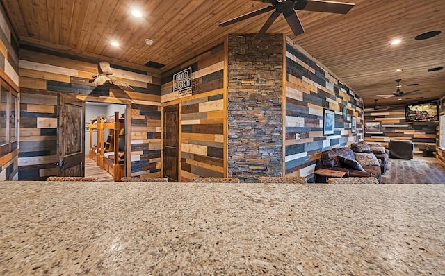 interior space with ceiling fan and wood ceiling