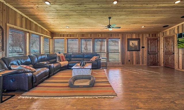 living room with hardwood / wood-style flooring, wooden ceiling, ceiling fan, and wood walls