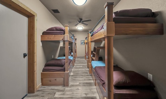 bedroom with ceiling fan and light wood-type flooring