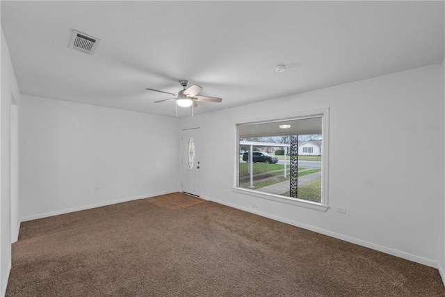 carpeted spare room featuring ceiling fan