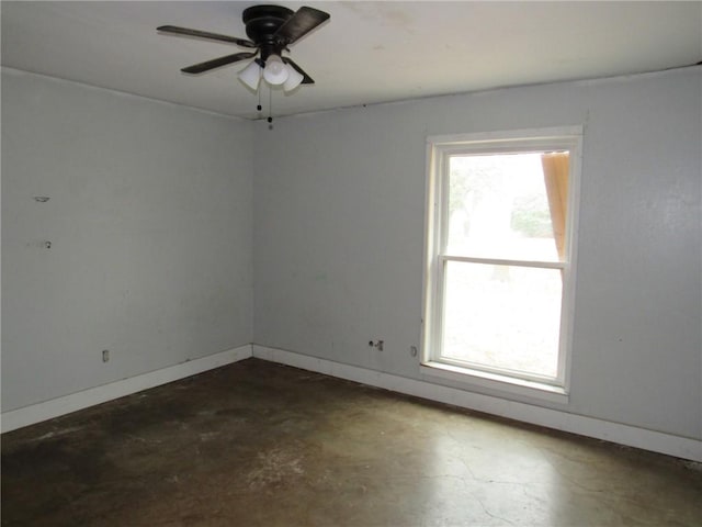 spare room featuring ceiling fan and a healthy amount of sunlight