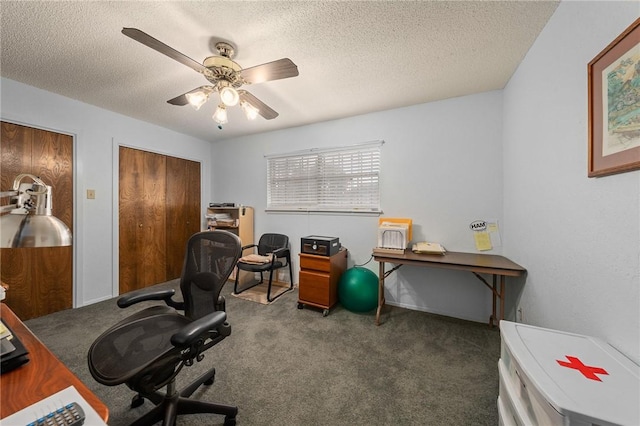 carpeted home office featuring ceiling fan and a textured ceiling