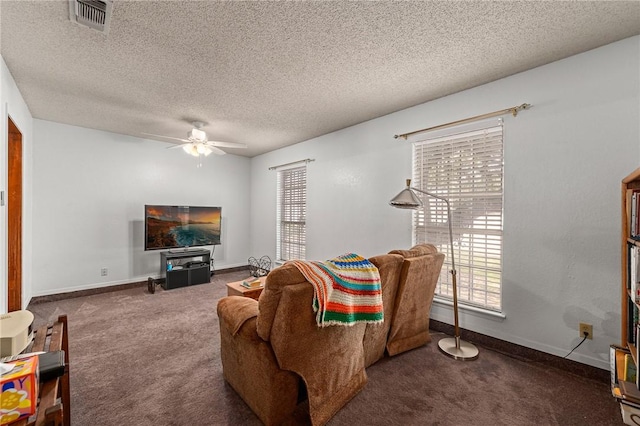 living room with ceiling fan, carpet, and a textured ceiling