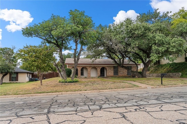 ranch-style house with a front lawn