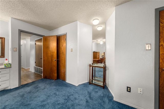 carpeted bedroom with a textured ceiling