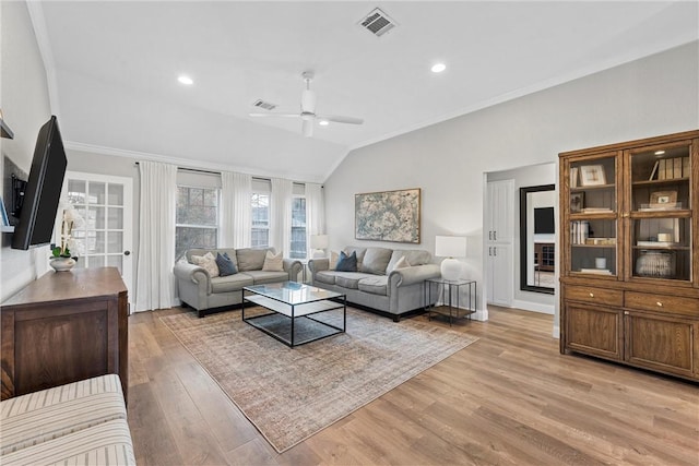 living room featuring lofted ceiling, crown molding, light hardwood / wood-style floors, and ceiling fan