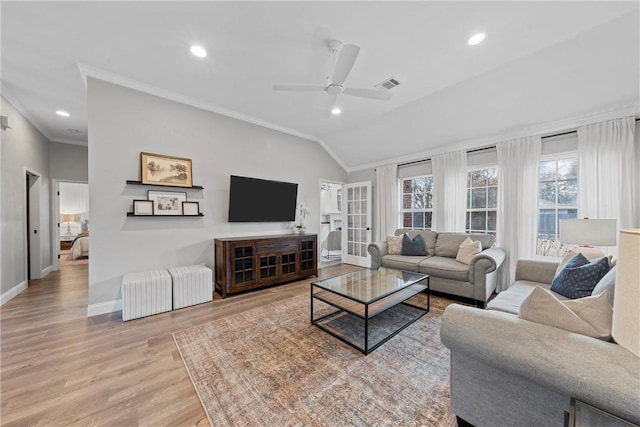 living room with crown molding, vaulted ceiling, ceiling fan, and light wood-type flooring