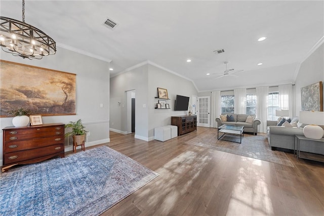 living room featuring crown molding, ceiling fan with notable chandelier, hardwood / wood-style floors, and french doors