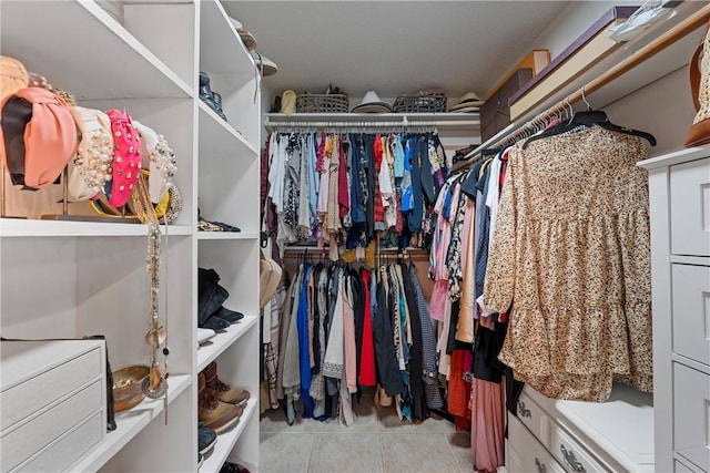 spacious closet with light tile patterned floors