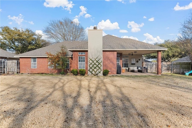 rear view of house with a yard and a patio area