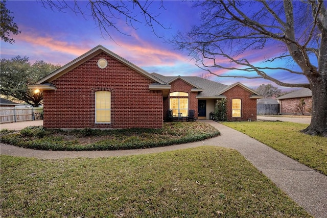 ranch-style house with a lawn