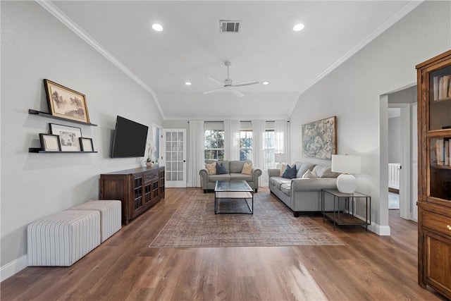 living room featuring hardwood / wood-style flooring, crown molding, and lofted ceiling