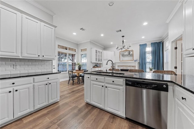 kitchen featuring hardwood / wood-style floors, sink, white cabinets, ornamental molding, and stainless steel dishwasher