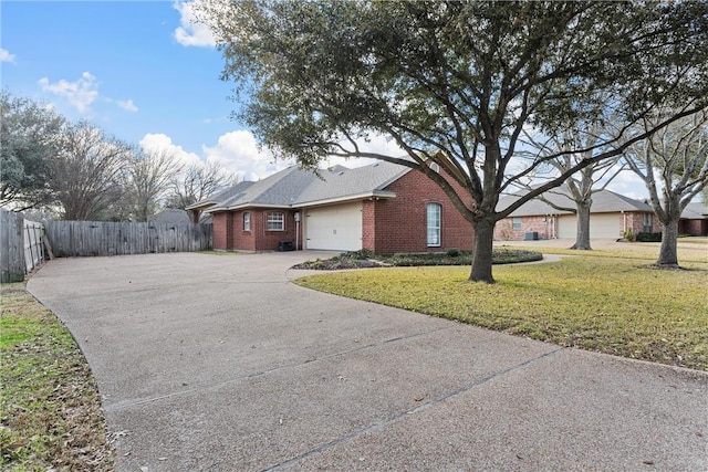 ranch-style home with a garage and a front yard