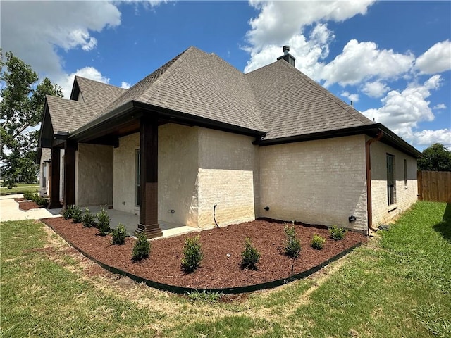 view of home's exterior featuring a lawn and a patio