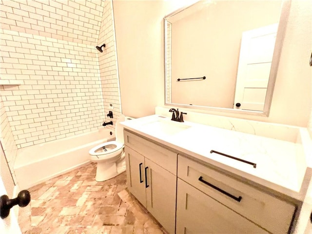 full bathroom with toilet, vanity, and tiled shower / bath