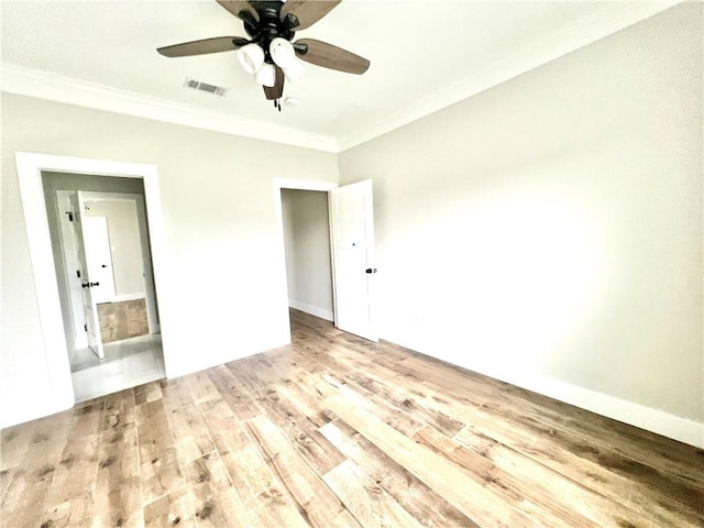 unfurnished bedroom featuring ceiling fan, light hardwood / wood-style floors, and crown molding