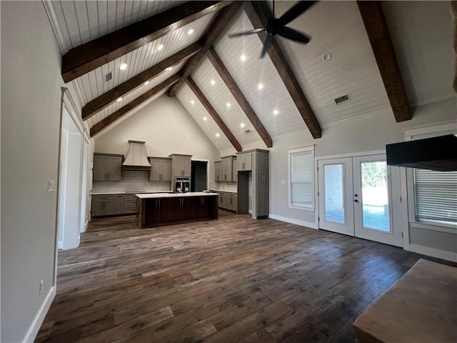 kitchen featuring french doors, a center island, dark hardwood / wood-style floors, and high vaulted ceiling