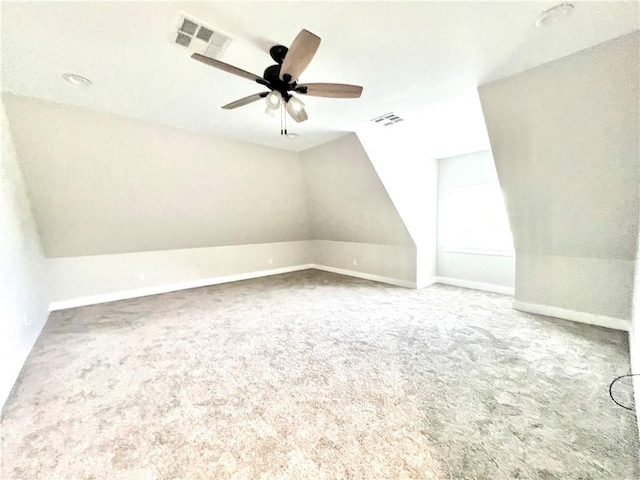 additional living space with carpet flooring, ceiling fan, and vaulted ceiling