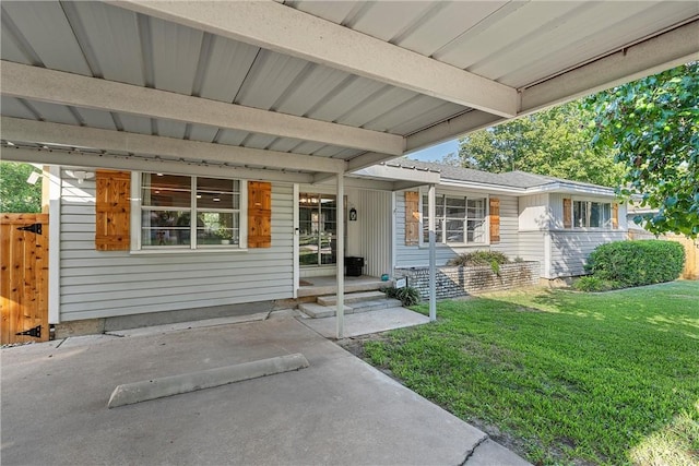 property entrance with a lawn