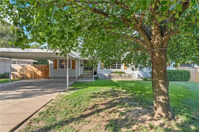 view of front facade with a carport and a front yard