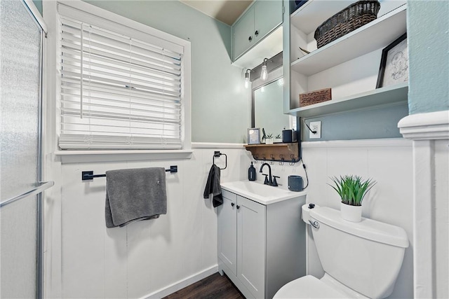 spare room featuring a wealth of natural light, ceiling fan, and hardwood / wood-style flooring