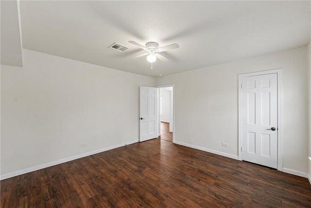 spare room with dark hardwood / wood-style floors and ceiling fan