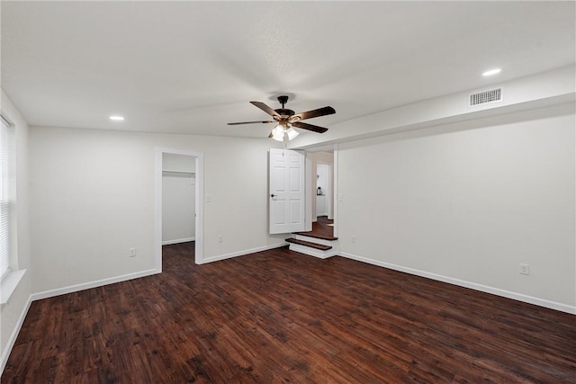 spare room featuring dark wood-type flooring and ceiling fan