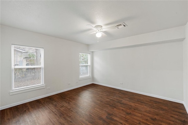 unfurnished room featuring dark wood-type flooring and ceiling fan