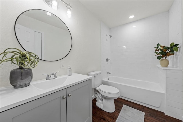 full bathroom with vanity, hardwood / wood-style floors,  shower combination, and toilet