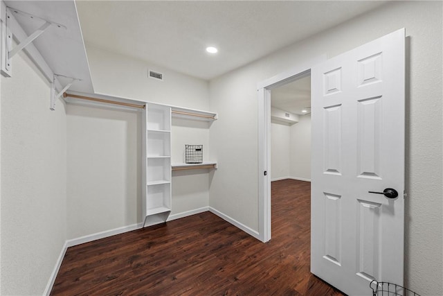 spacious closet featuring dark hardwood / wood-style floors