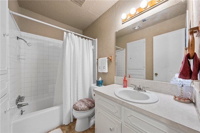 full bathroom with shower / tub combo with curtain, vanity, toilet, and a textured ceiling