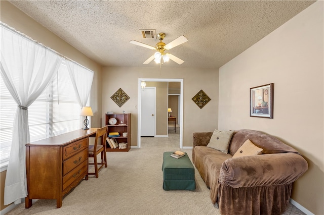 interior space featuring ceiling fan and a textured ceiling