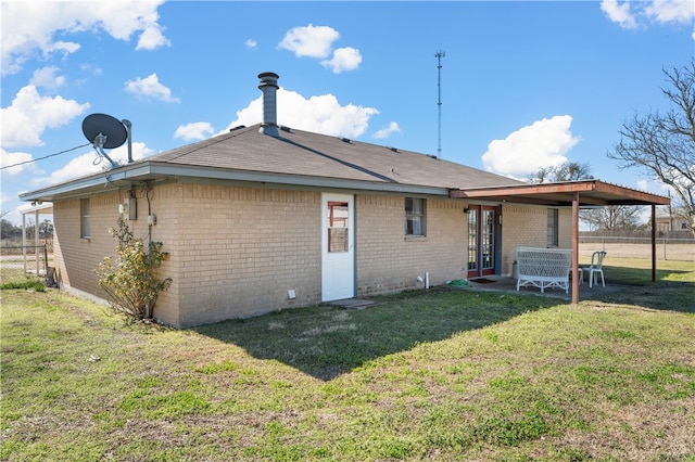 rear view of property featuring a yard