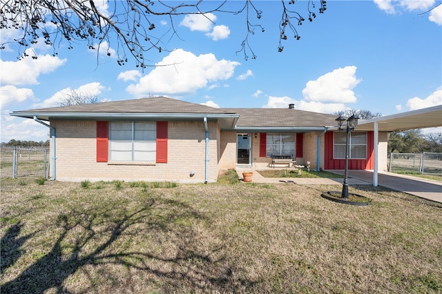 ranch-style home with a carport and a front lawn