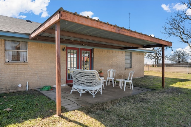 rear view of house with a patio area and a lawn