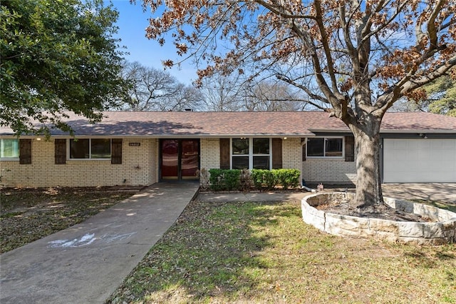 single story home with a garage and a front lawn