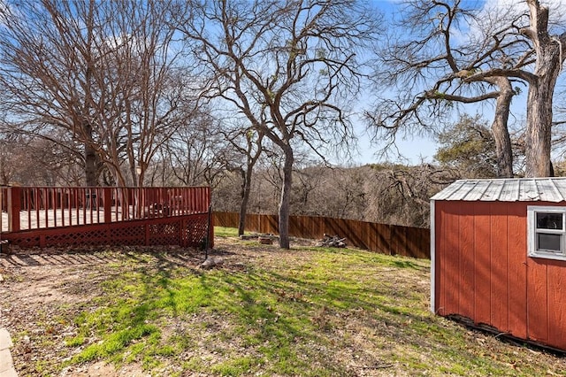 view of yard with a wooden deck and a shed