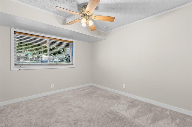 unfurnished room with ceiling fan, ornamental molding, a textured ceiling, and carpet flooring