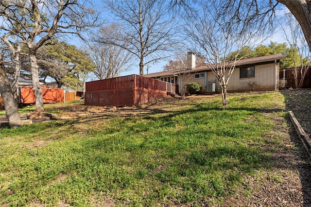 view of yard featuring cooling unit and a deck