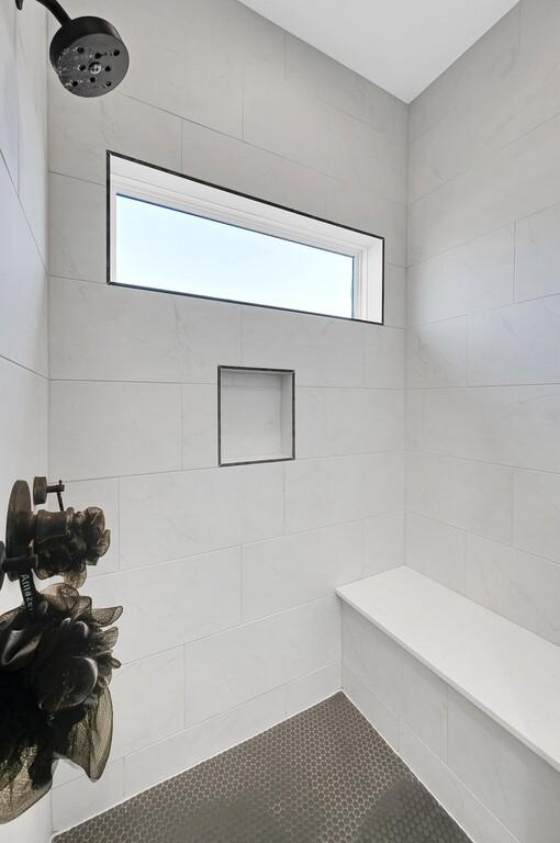 bathroom with a tile shower